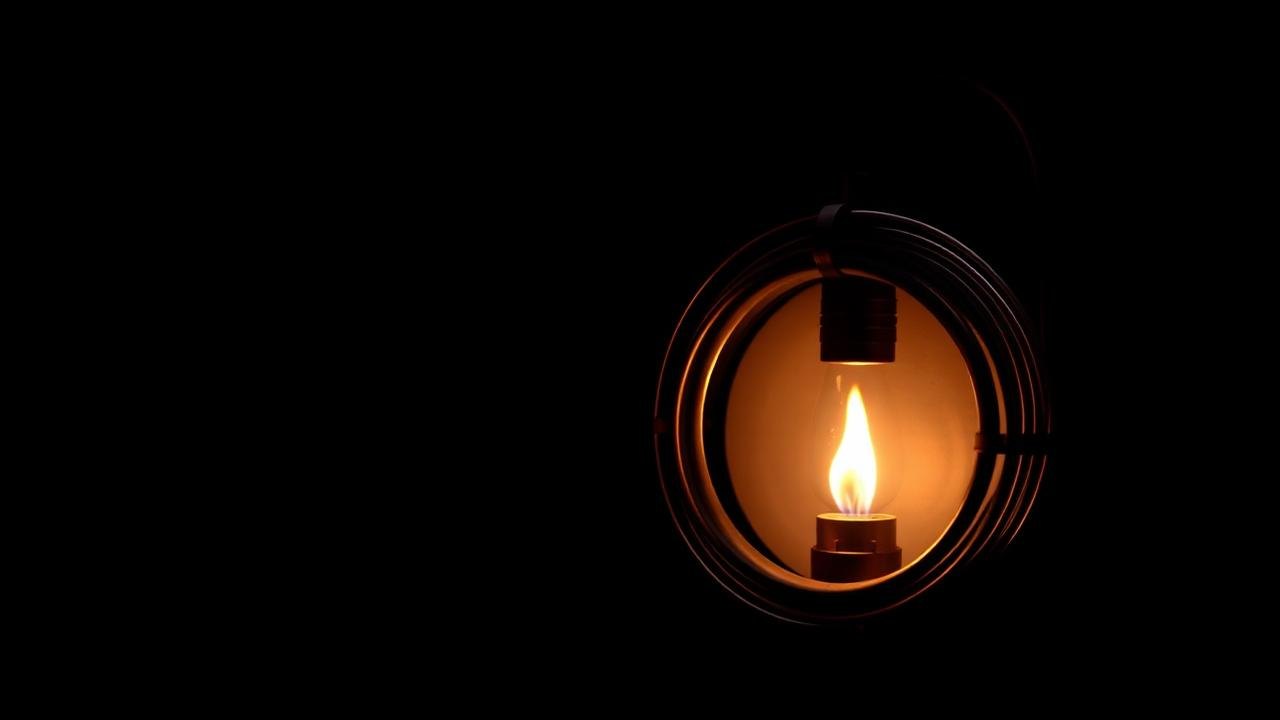 Micro-gasifier cookstove with an annular metal heat exchanger and a small lamp
